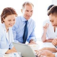Presentation expert - David D. Doerrier speaking to businessman with team on meeting in office
